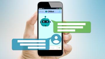 a hand holding a cell phone with Chat Bot features 