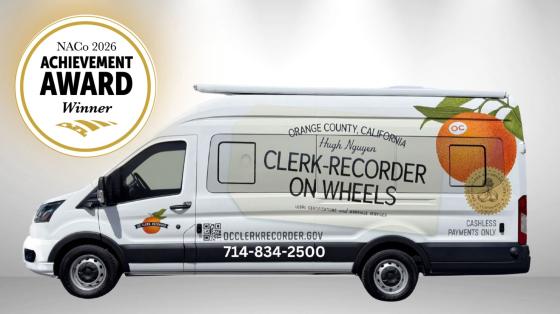 Naco Achievement Award Winner in White Circle in Top Left Corner with Golden Outline, White Van with an orange on the window with information about Clerk-Recorder on Wheels