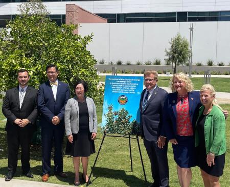Clerk-Recorder Hugh Nguyen attending the orange tree dedication with the Board of Supervisors and Treasurer-Tax Collector.