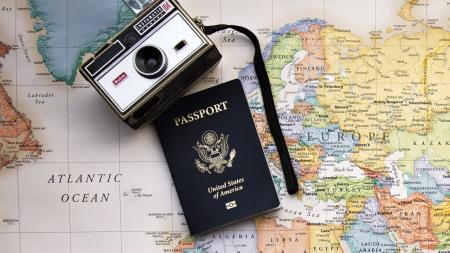 Camera, passport book and map